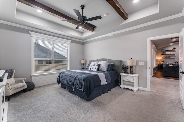 carpeted bedroom featuring crown molding, beam ceiling, and a tray ceiling