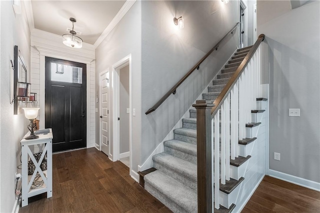 entrance foyer with stairs, crown molding, wood finished floors, and baseboards