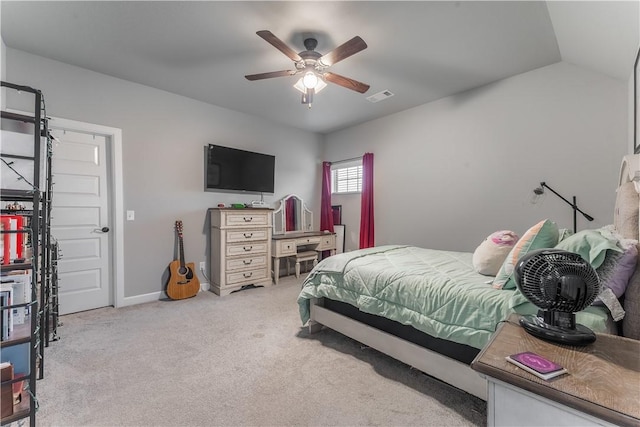 bedroom featuring vaulted ceiling, light colored carpet, and ceiling fan