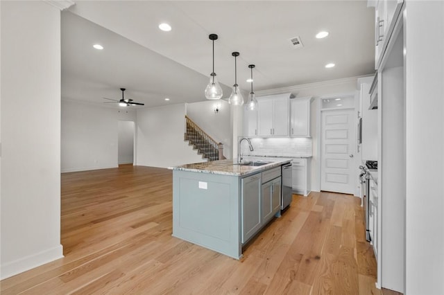 1808 Charles St, Pea Ridge, AR 72751 - kitchen with white cabinets, ceiling fan, backsplash, dishwasher, and hanging light fixtures