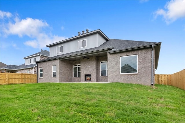 1808 Charles St, Pea Ridge, AR 72751 - rear view of house featuring ceiling fan, a fenced backyard, and brick siding