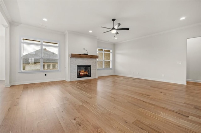 1808 Charles St, Pea Ridge, AR 72751 - unfurnished living room with a ceiling fan, crown molding, plenty of natural light, a glass covered fireplace, and light wood-type flooring