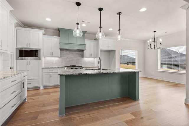 1808 Charles St, Pea Ridge, AR 72751 - kitchen with appliances with stainless steel finishes, ornamental molding, a chandelier, decorative backsplash, and white cabinetry