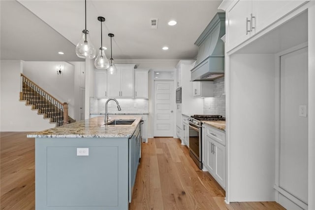 1808 Charles St, Pea Ridge, AR 72751 - kitchen featuring gas range, custom range hood, tasteful backsplash, recessed lighting, and light stone countertops