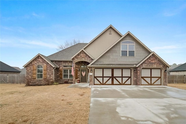 view of front of home with a garage and a front lawn