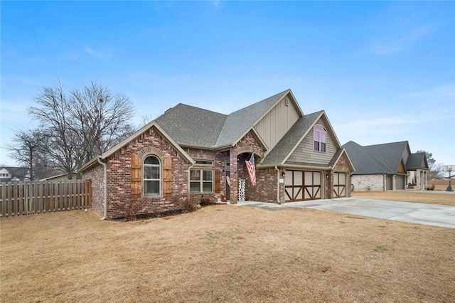 view of front of house featuring a garage and a front lawn