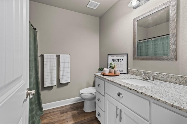 bathroom with vanity, hardwood / wood-style floors, and toilet