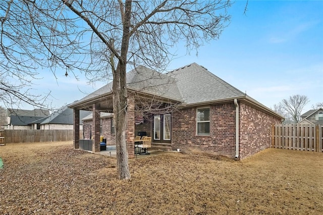 rear view of house featuring a patio and a lawn