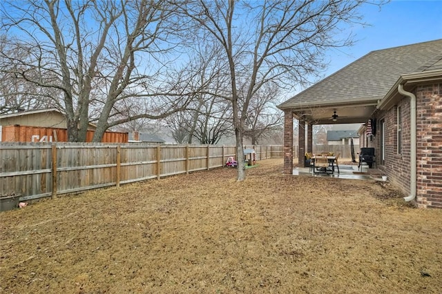 view of yard featuring ceiling fan and a patio