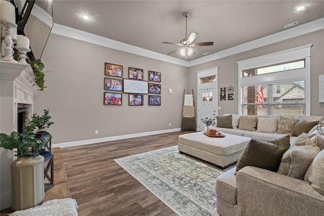 living room with ornamental molding, ceiling fan, and dark hardwood / wood-style flooring