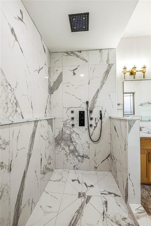 bathroom with vanity, tile walls, and a tile shower