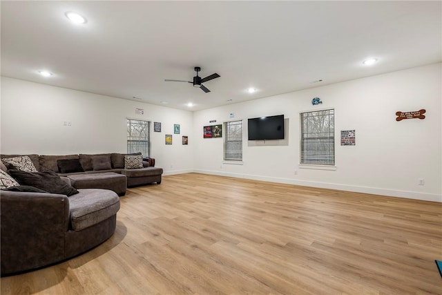 living room with ceiling fan and light hardwood / wood-style floors