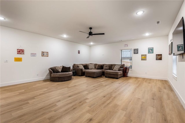 living room with ceiling fan and light hardwood / wood-style floors