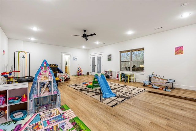 recreation room with hardwood / wood-style floors, french doors, and ceiling fan