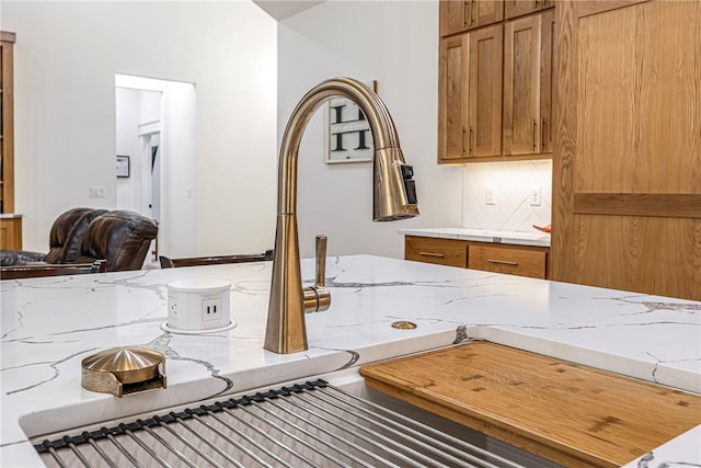 interior details featuring decorative backsplash and light stone countertops