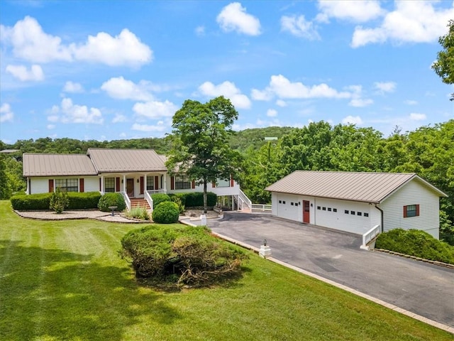 single story home featuring a garage and a front yard