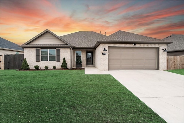 view of front of home featuring a garage and a yard