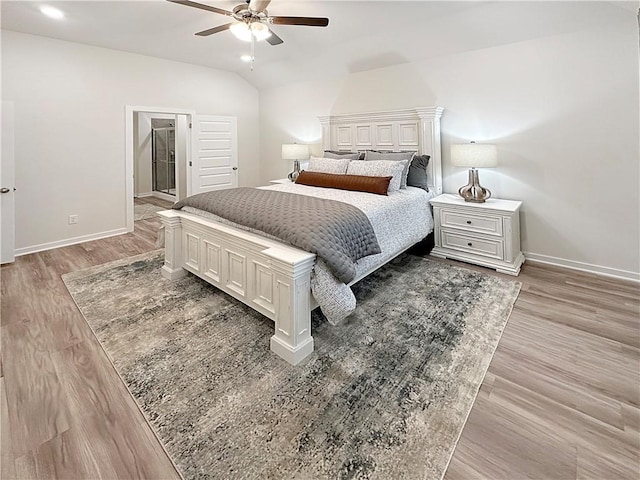 bedroom with ceiling fan, lofted ceiling, and light hardwood / wood-style flooring