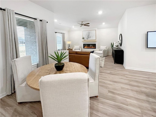 dining space with light hardwood / wood-style flooring and ceiling fan