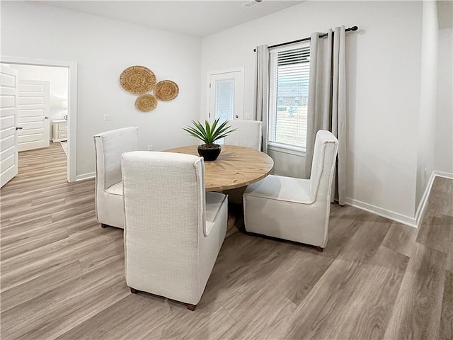 dining space with light wood-type flooring