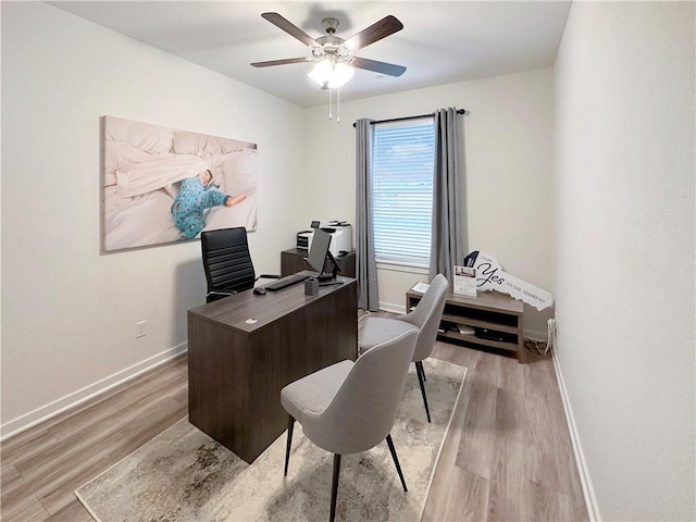 home office featuring ceiling fan and light hardwood / wood-style floors