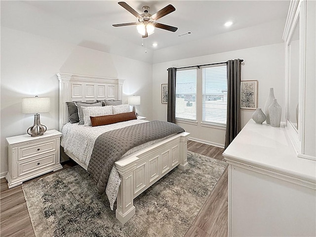 bedroom with ceiling fan and dark hardwood / wood-style floors