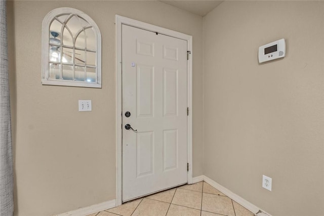 doorway featuring light tile patterned flooring