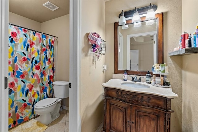 bathroom with a shower with curtain, vanity, toilet, and tile patterned flooring