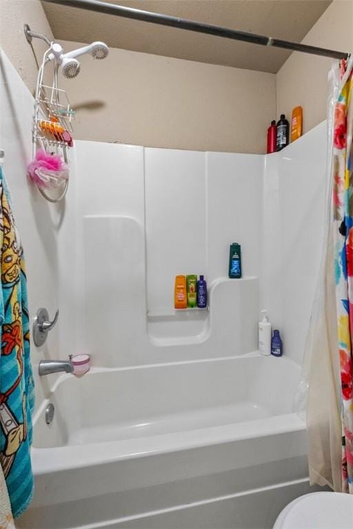 bathroom with toilet and shower / bath combo