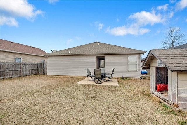 back of property featuring a storage shed, a yard, and a patio area