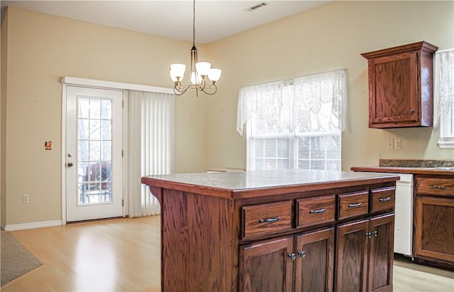 kitchen with a chandelier, a center island, hanging light fixtures, and light wood-type flooring