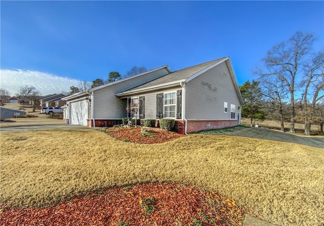 view of front of house with a garage, driveway, and a front lawn