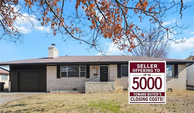 view of front of home featuring a garage, driveway, crawl space, brick siding, and a chimney