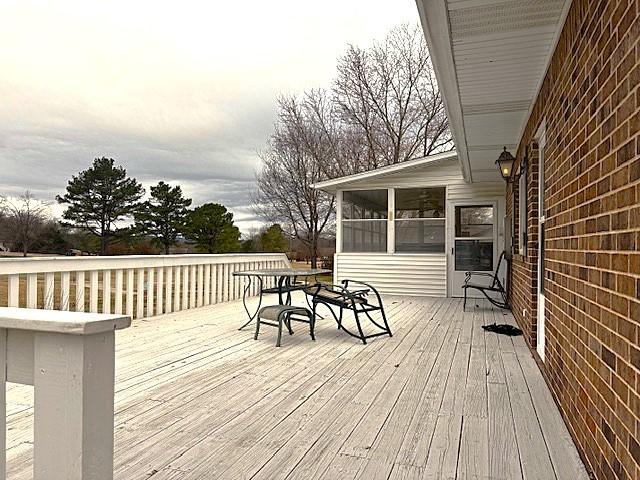 deck with a sunroom