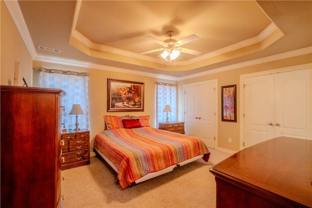 13 Smart Ln, Bella Vista, AR 72715 - bedroom featuring a tray ceiling, crown molding, light colored carpet, two closets, and a ceiling fan
