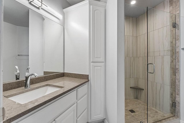 full bathroom featuring a stall shower and vanity