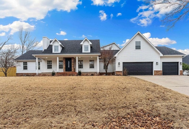 view of front of property with covered porch, driveway, a front lawn, and a chimney