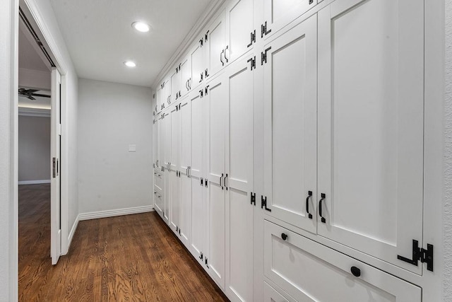mudroom featuring dark wood-type flooring, recessed lighting, and baseboards