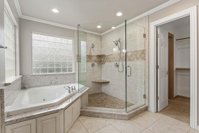 full bath with a jetted tub, tile patterned flooring, a spacious closet, crown molding, and a shower stall