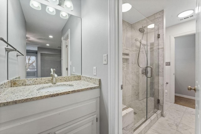 bathroom with marble finish floor, a shower stall, visible vents, and vanity