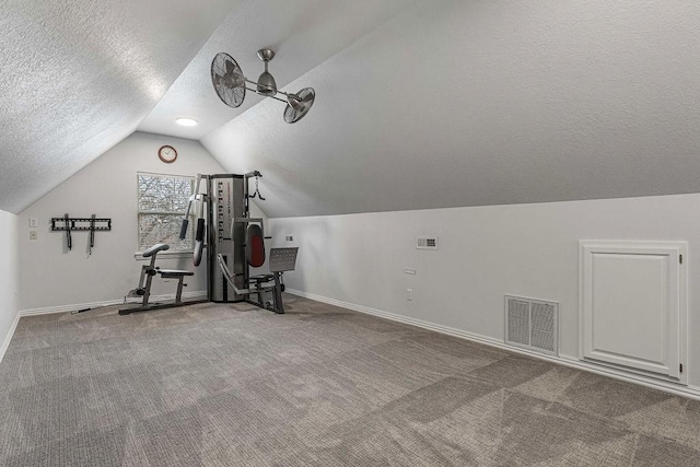 workout room featuring baseboards, visible vents, lofted ceiling, a textured ceiling, and carpet flooring