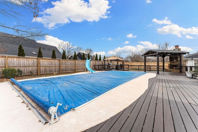 view of pool with a gazebo, a fenced backyard, and a wooden deck