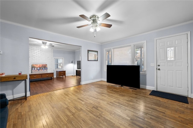 entrance foyer featuring ornamental molding, hardwood / wood-style floors, and ceiling fan