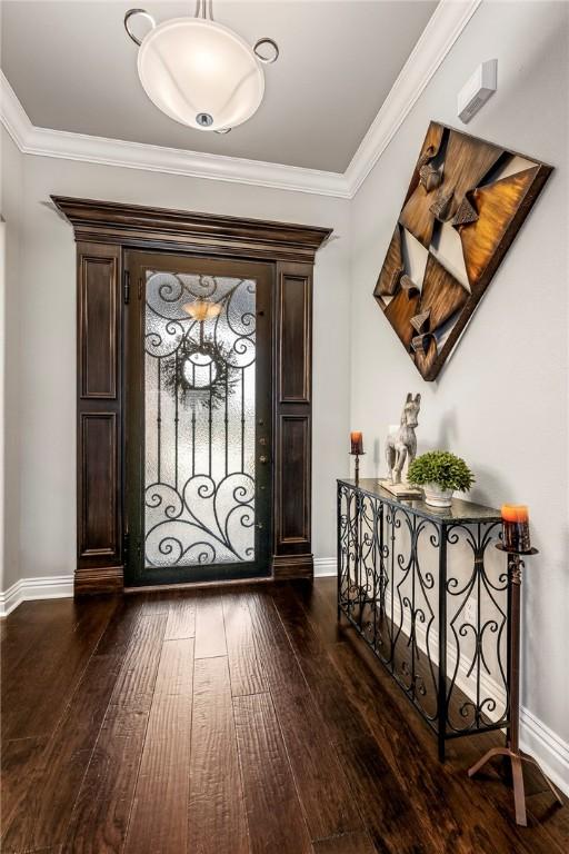 foyer featuring crown molding and dark hardwood / wood-style floors