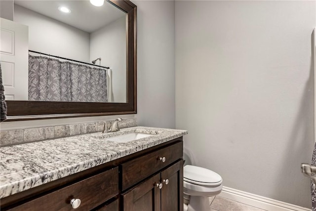 bathroom featuring vanity, tile patterned flooring, and toilet