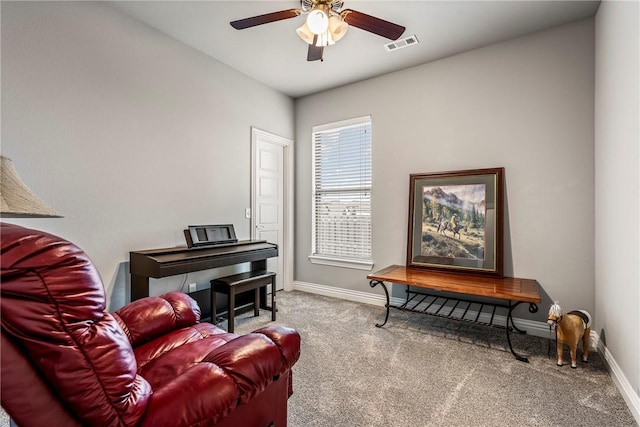 sitting room featuring ceiling fan and carpet flooring