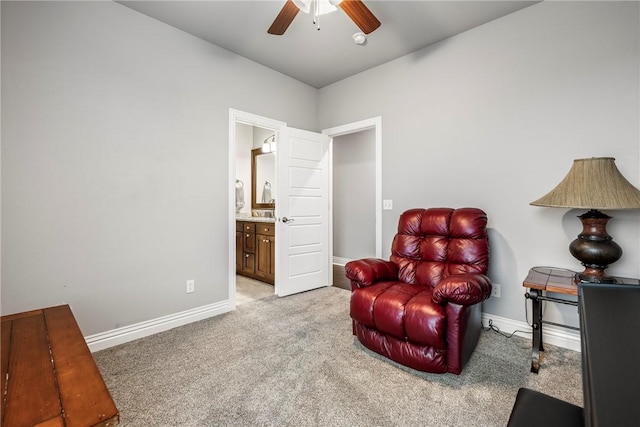 living area featuring light colored carpet and ceiling fan