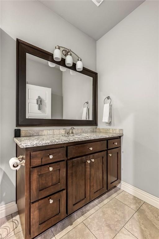 bathroom with vanity and tile patterned floors