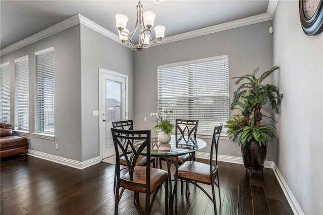 dining area with ornamental molding, dark wood-type flooring, and a notable chandelier