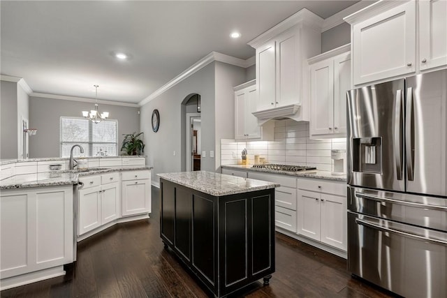 kitchen featuring sink, kitchen peninsula, white cabinets, and appliances with stainless steel finishes